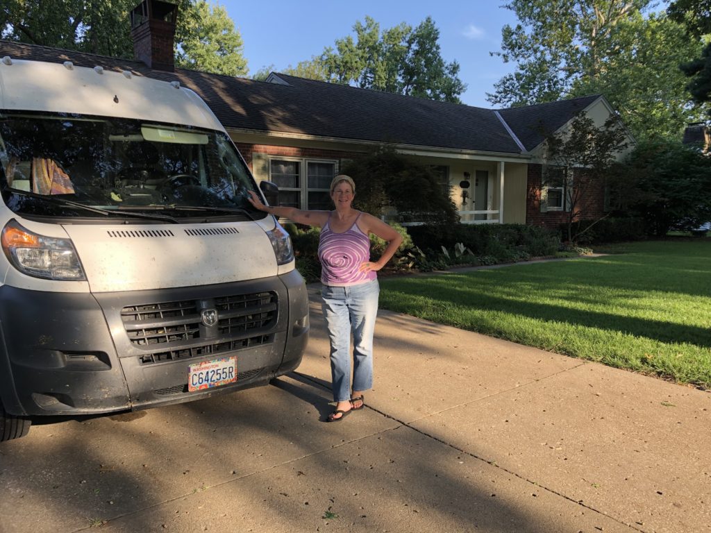 Carrie Kenner stands in front of white van in driveway in Kansas City